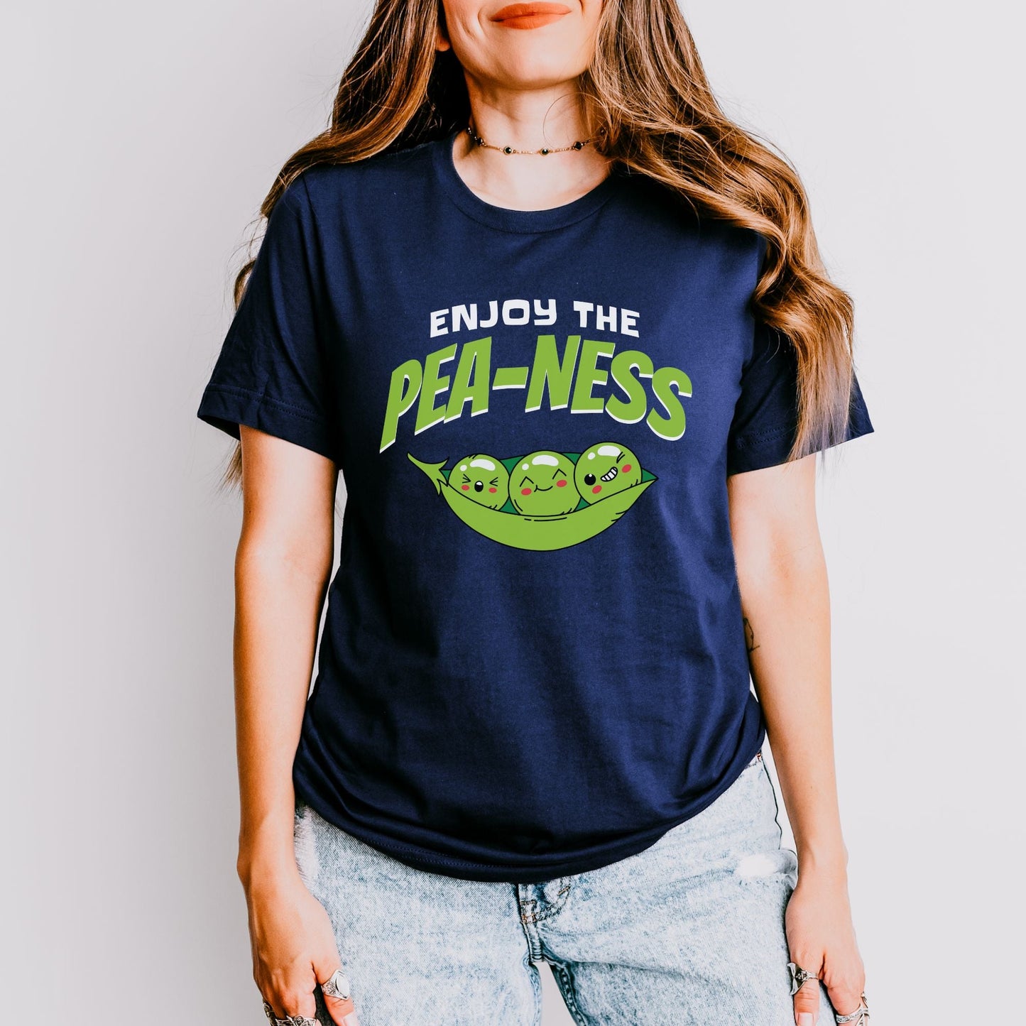 a woman wearing a t - shirt that says enjoy the pea - nesss
