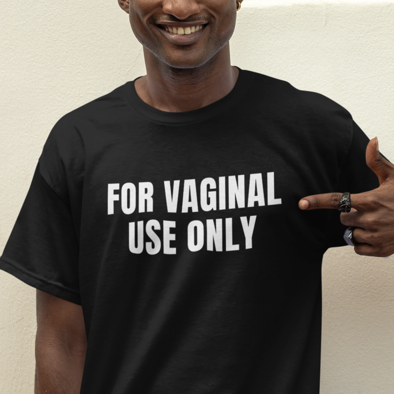 a man pointing to the side of his shirt that says for vaginal use