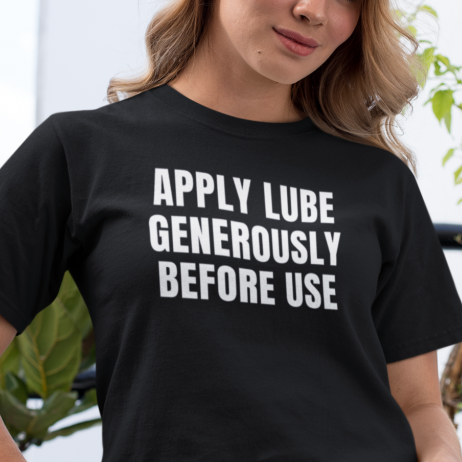 a woman wearing a black t - shirt that says apply lube generous before use