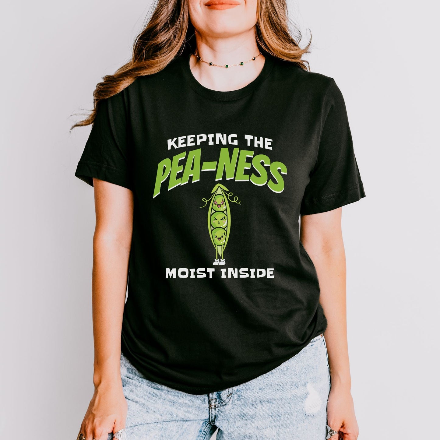 a woman wearing a t - shirt that says, keeping the pea - nesss