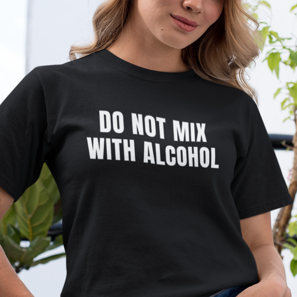 a woman wearing a do not mix with alcohol t - shirt