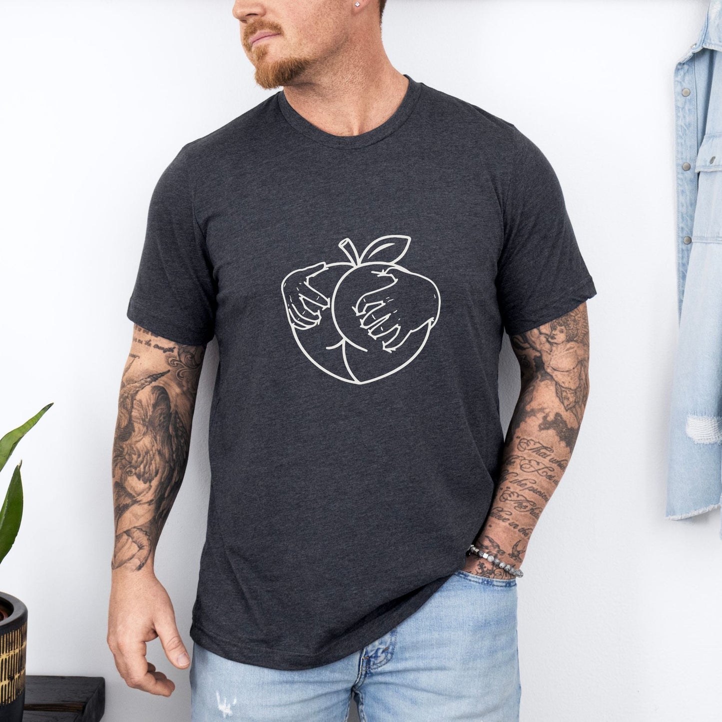 a man wearing a black shirt with an apple on it