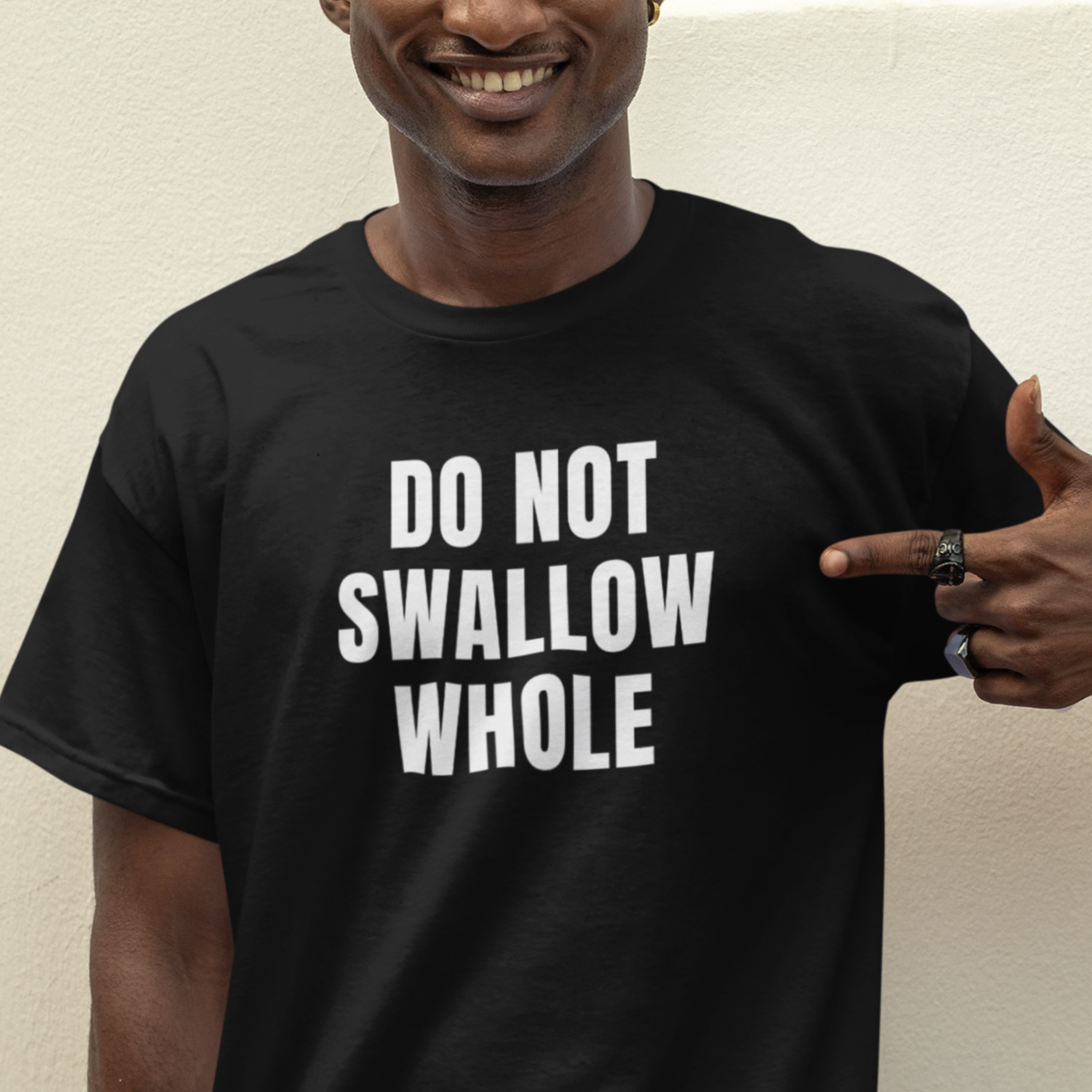 a man wearing a t - shirt that says do not swallow whole
