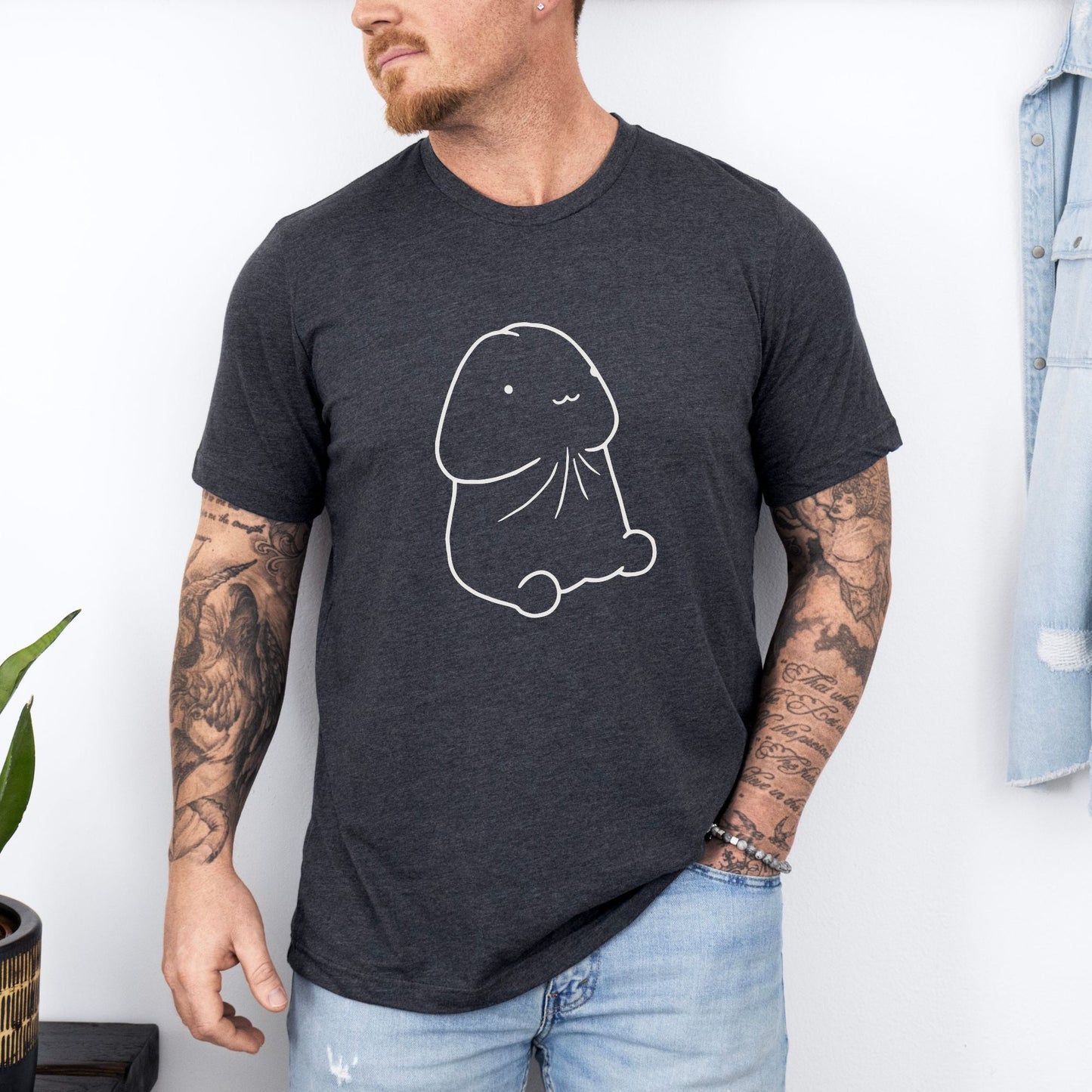 a man wearing a black t - shirt with a drawing of a fish on it