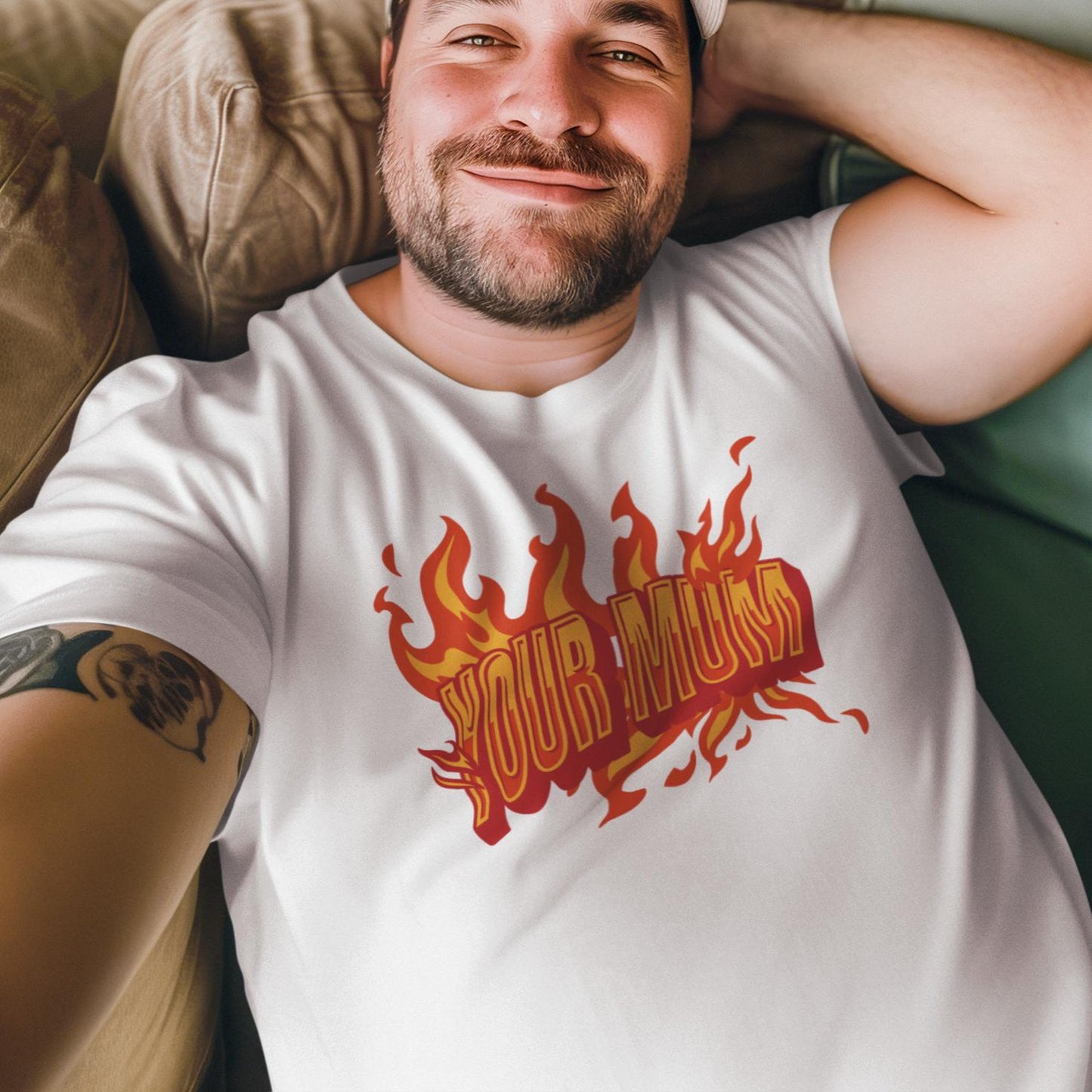 a man laying on a couch wearing a shirt with flames on it