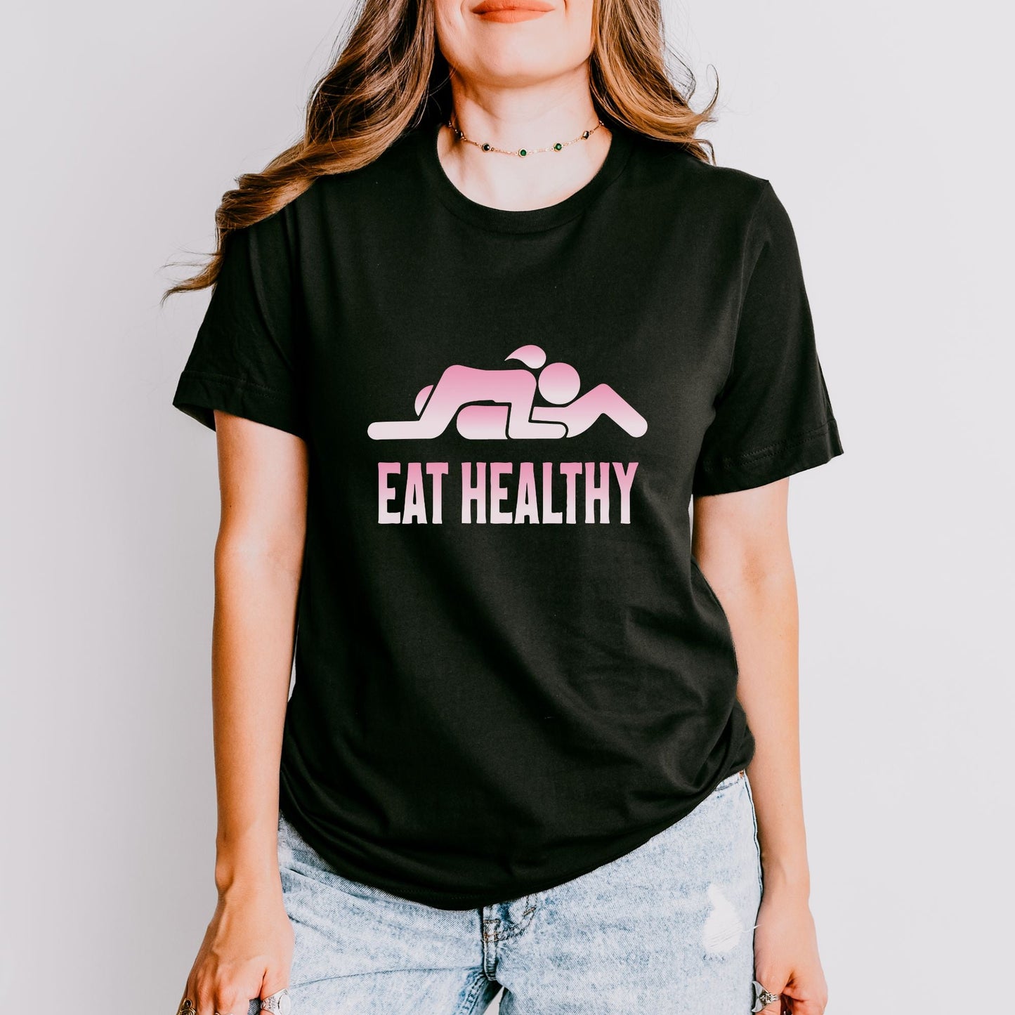 a woman wearing a t - shirt that says eat healthy