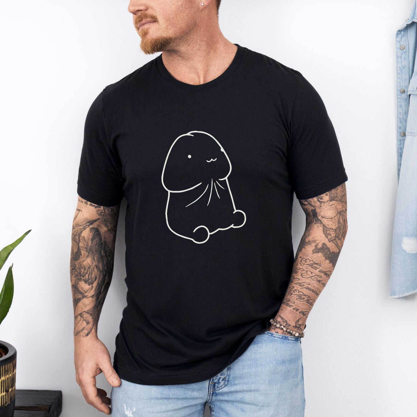 a man wearing a black shirt with a drawing of a dog on it