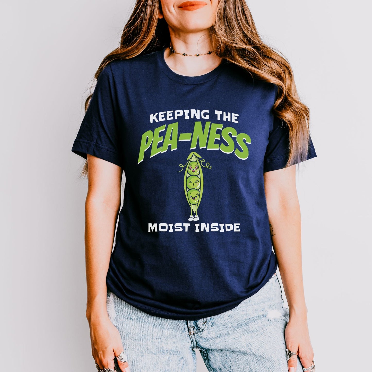 a woman wearing a t - shirt that says keeping the pea - nesss most