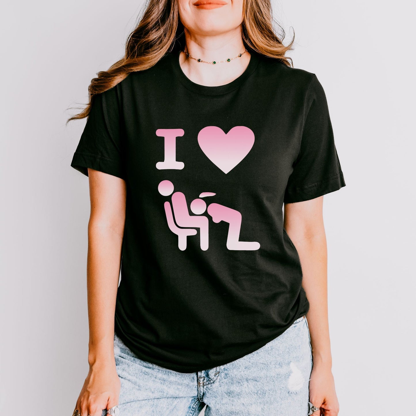 a woman wearing a black shirt with a pink heart on it