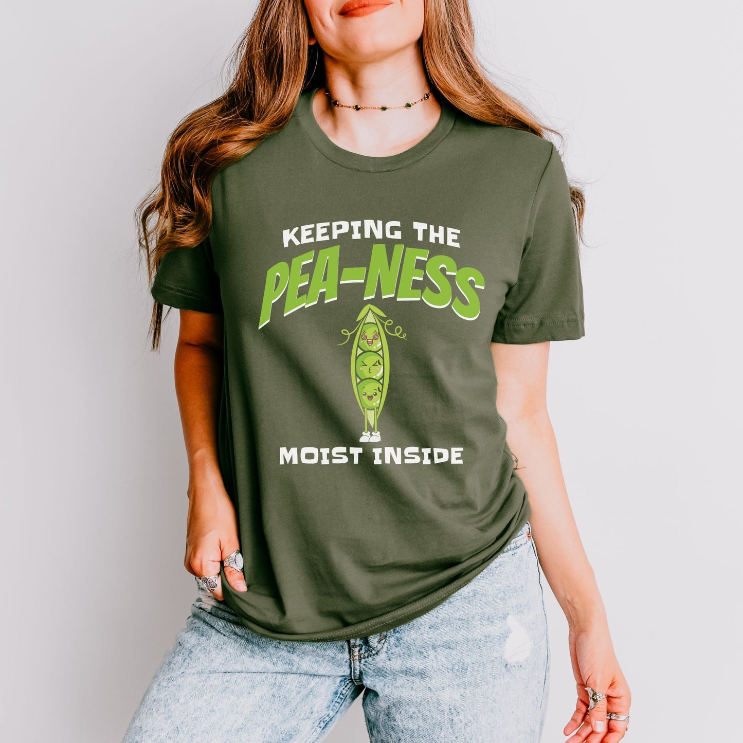 a woman wearing a t - shirt that says keeping the pea - less most inside