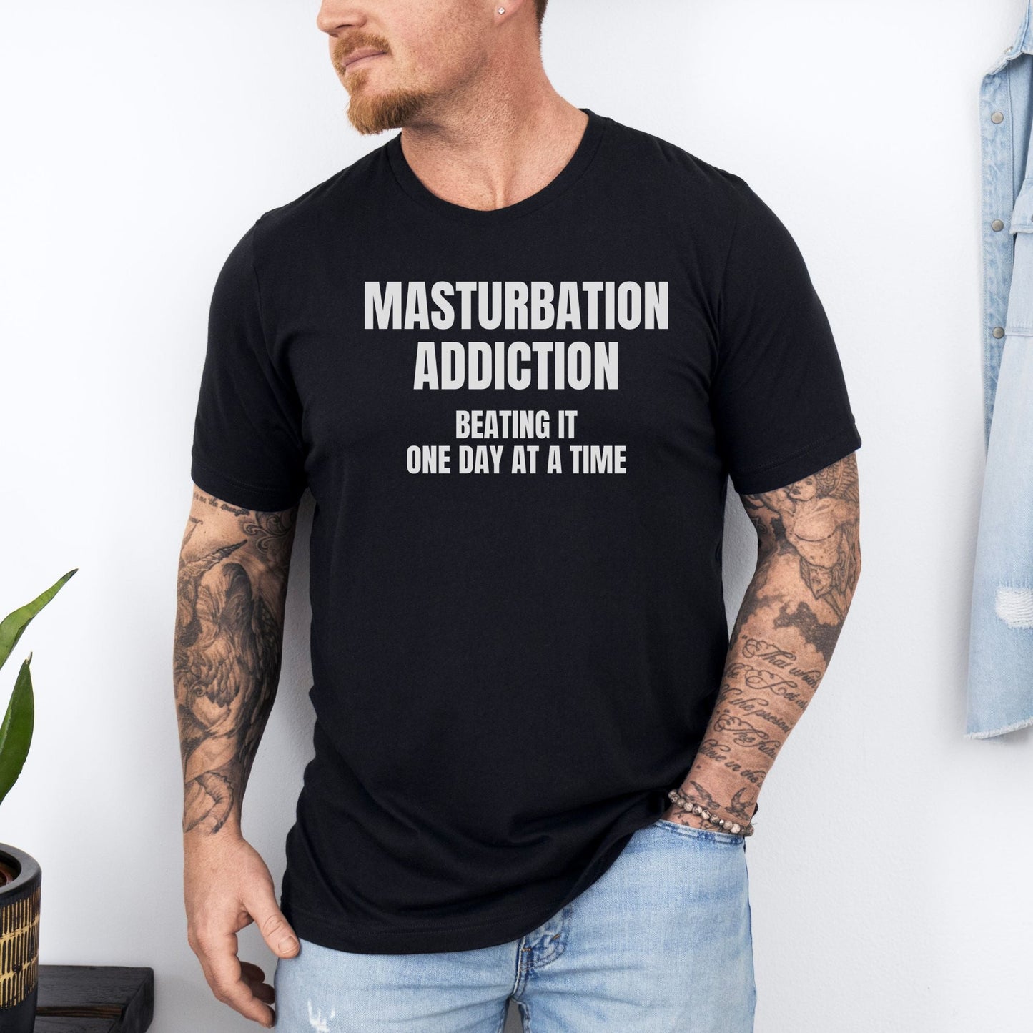 a man wearing a black t - shirt that says, masturption addition being
