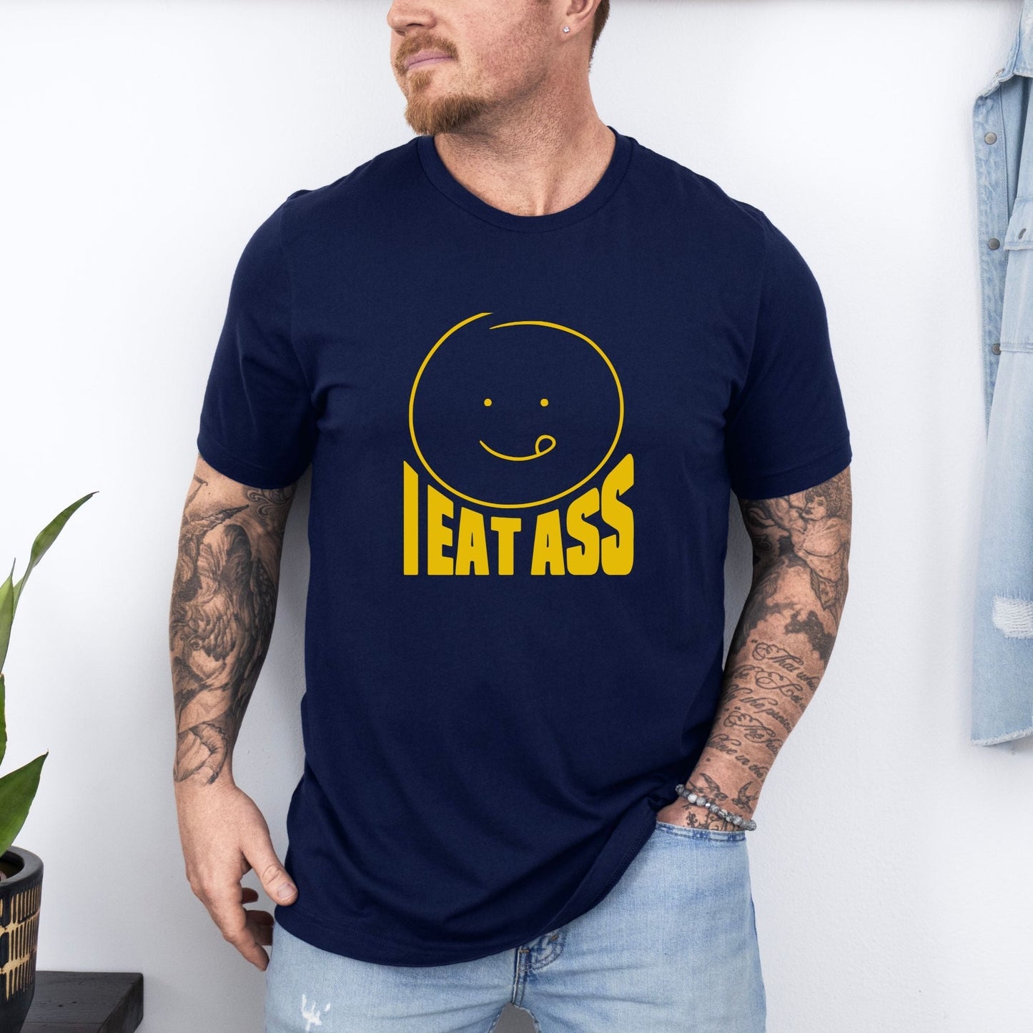 a man wearing a t - shirt that says eat ass