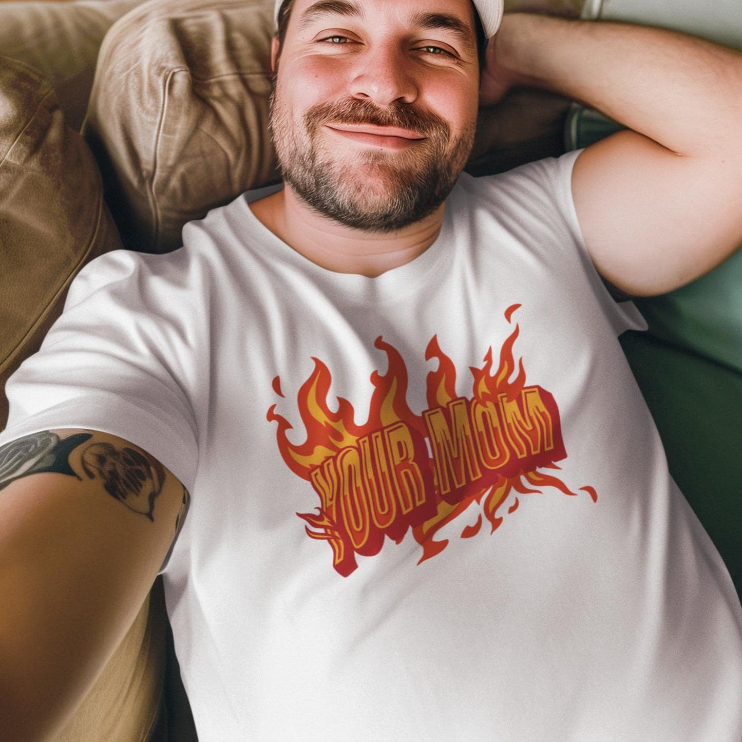 a man laying on a couch wearing a shirt with flames on it