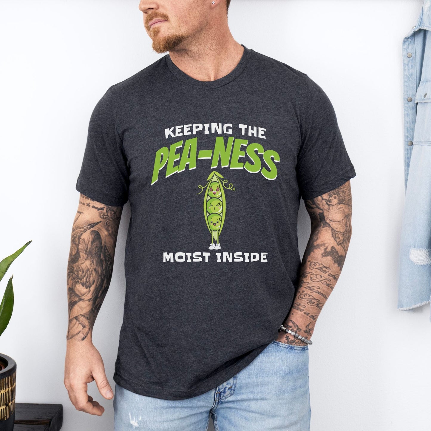 a man wearing a t - shirt that says keeping the pea - ness inside
