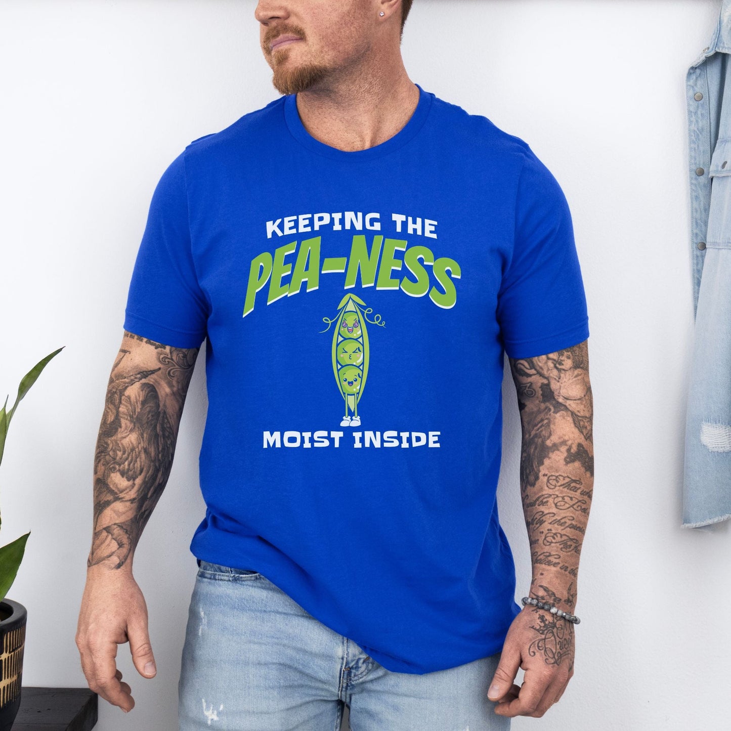 a man with a beard wearing a blue shirt