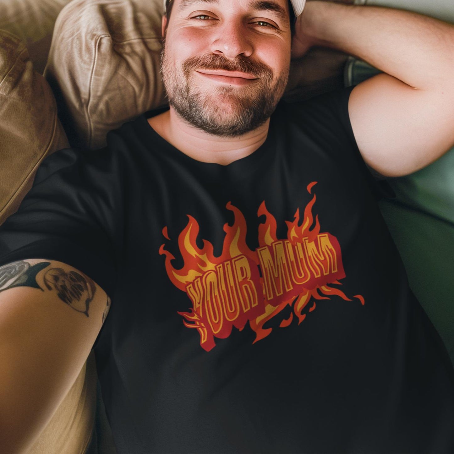 a man laying on a couch wearing a black shirt