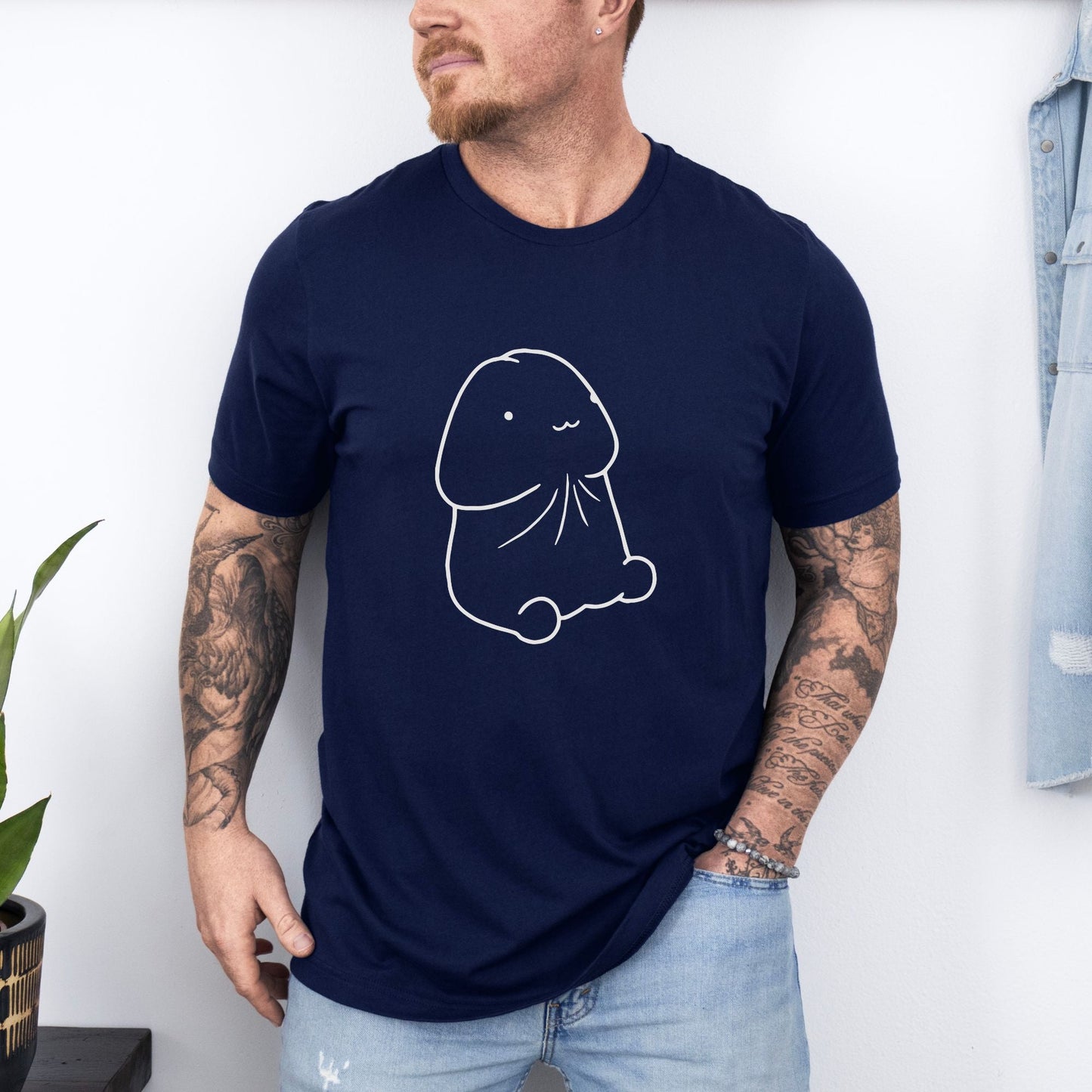 a man wearing a blue t - shirt with a drawing of a dog on it