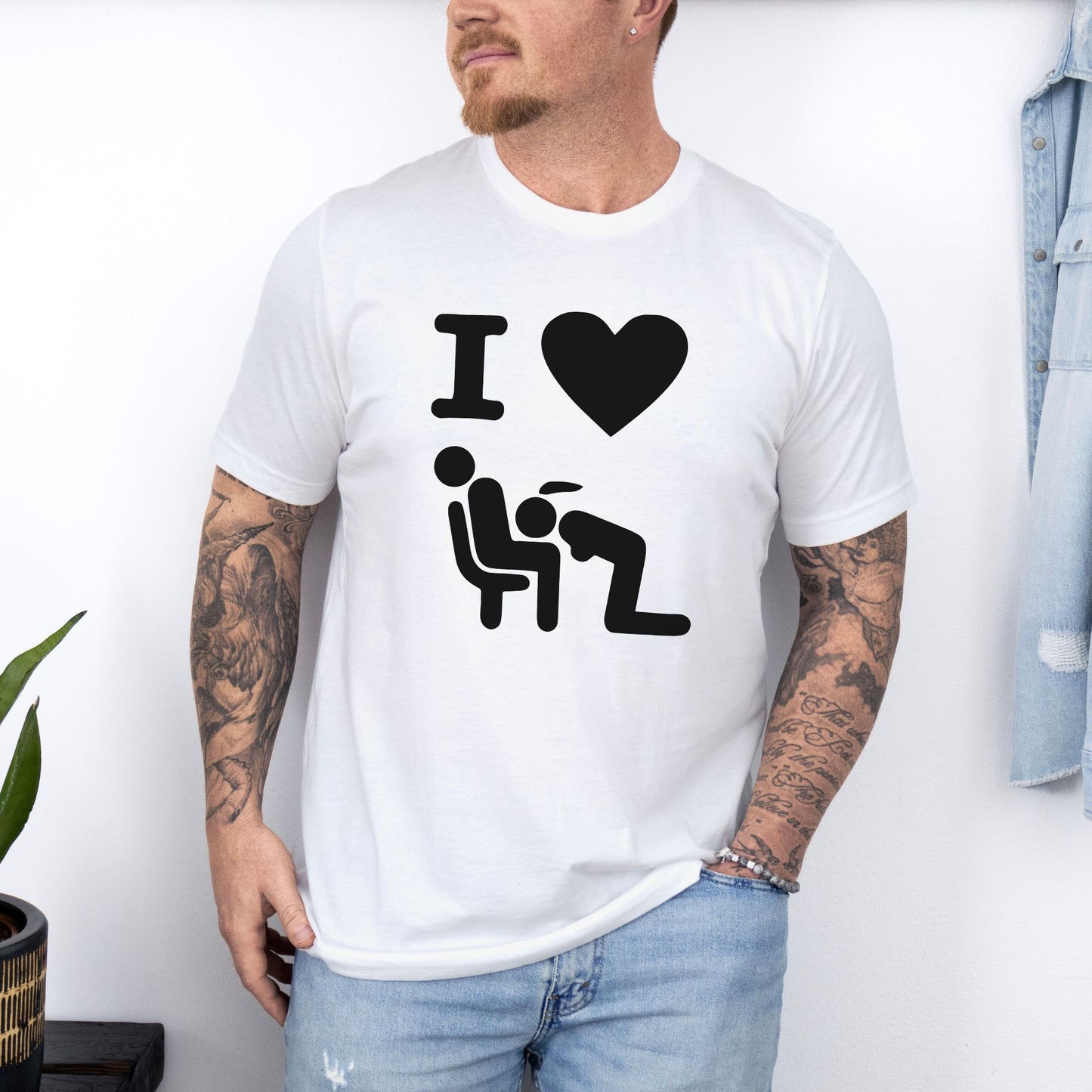 a man wearing a white t - shirt with the words i love him on it