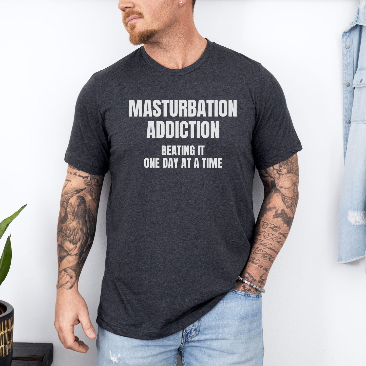 a man wearing a black t - shirt that says, masturption addition being