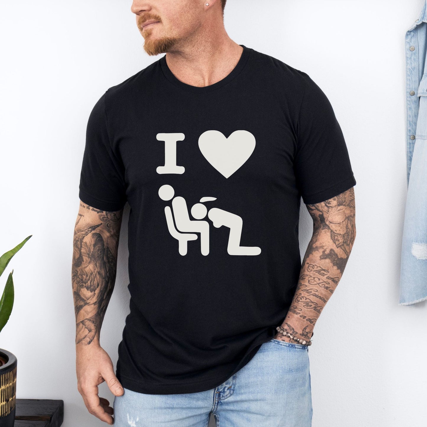 a man wearing a black t - shirt with the words i love him on it