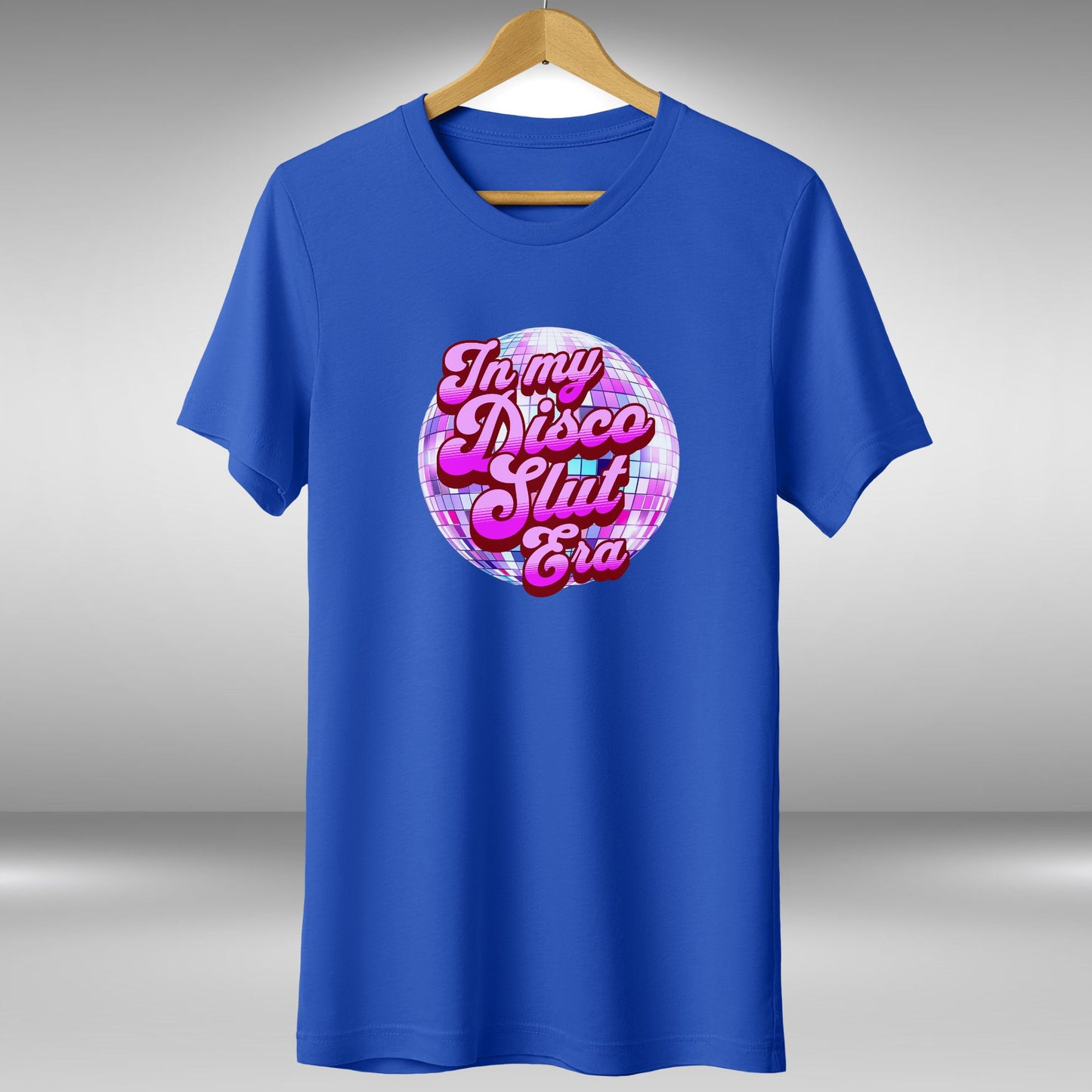 A blue t-shirt with a graphic design featuring a disco ball and the text "In my disco slut era" printed on it.