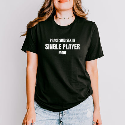 a woman wearing a black shirt that says practicing sex in single player mode