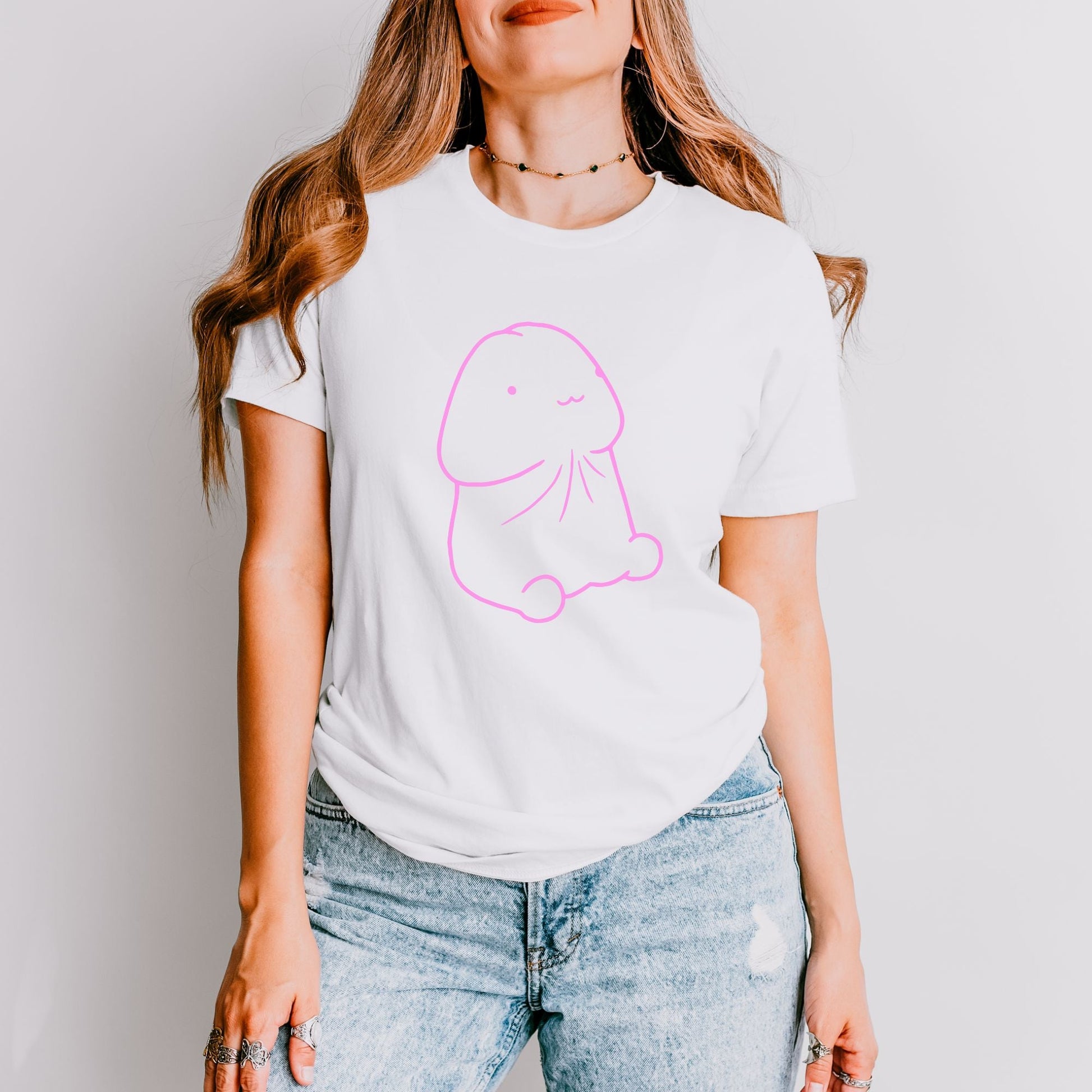 a woman wearing a white t - shirt with a pink elephant on it