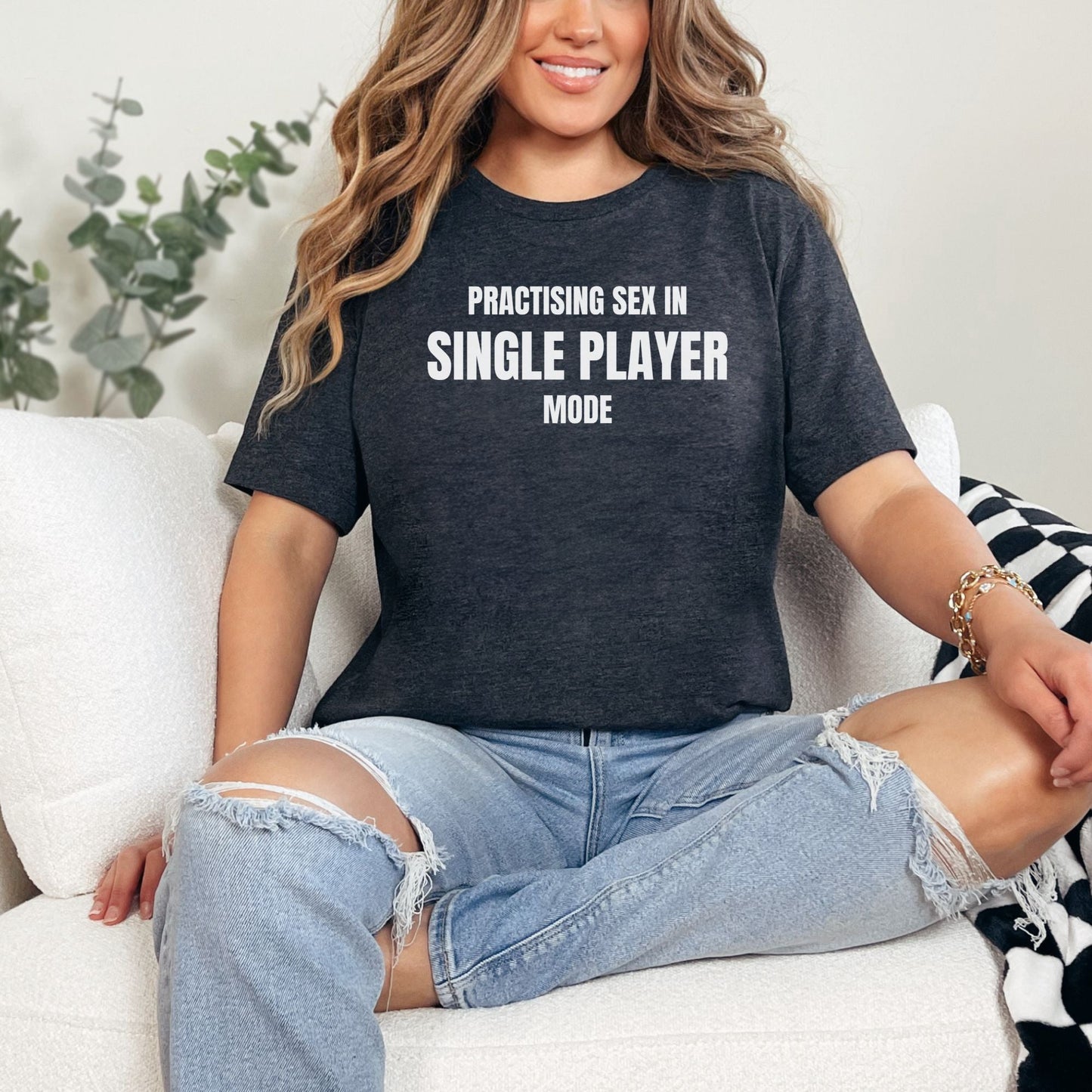a woman sitting on a couch with her legs crossed