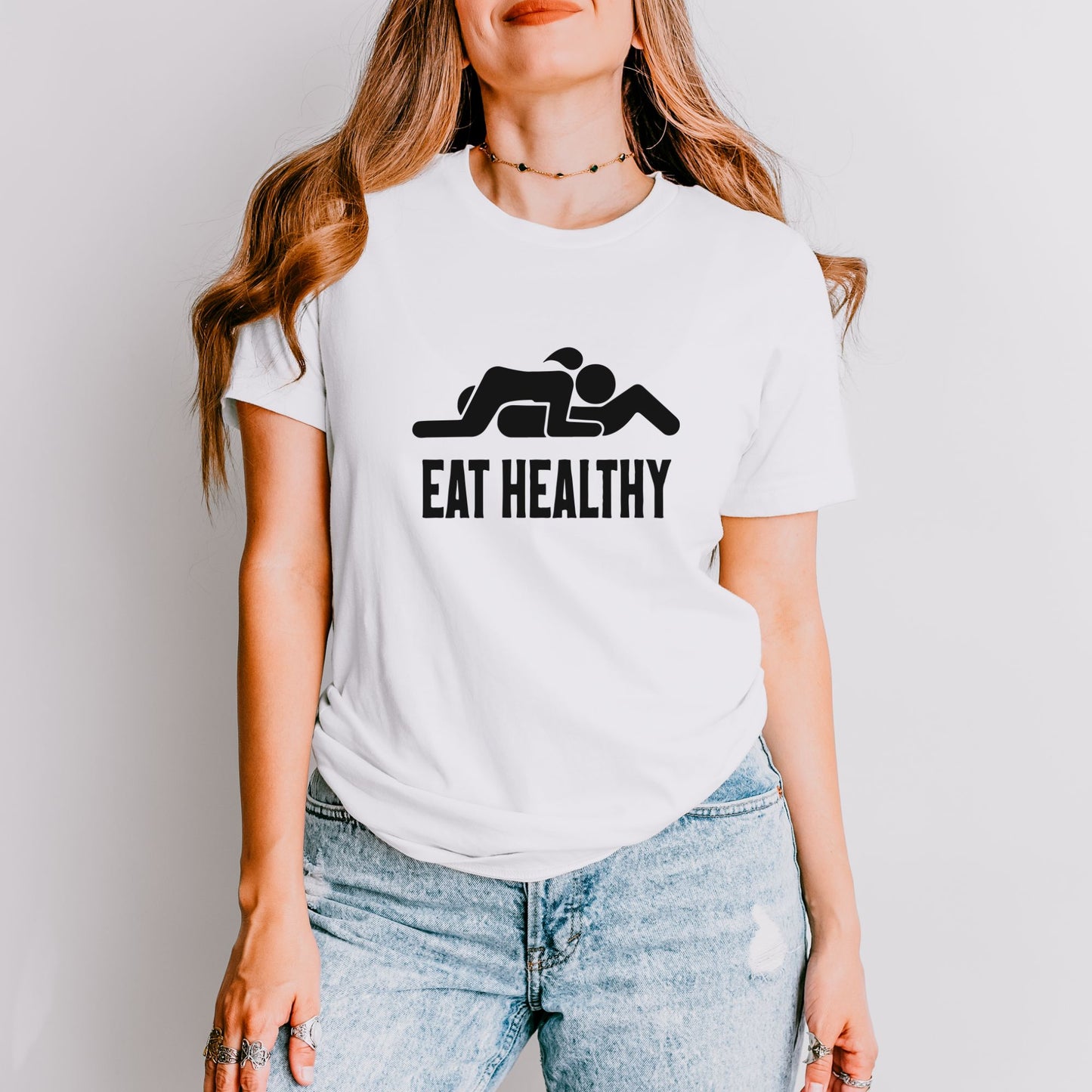 a woman wearing a t - shirt that says eat healthy