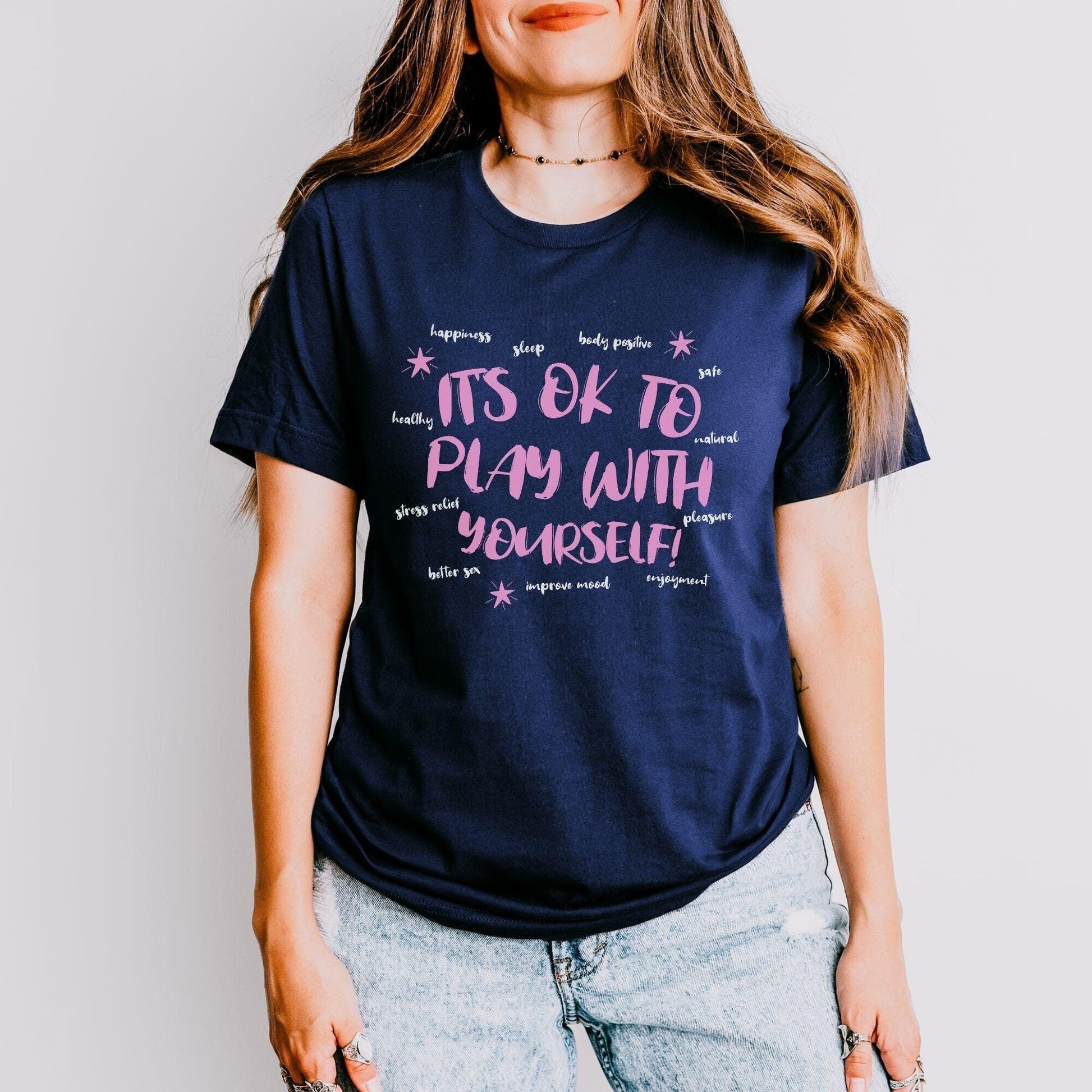 a woman wearing a t - shirt that says it&#39;s ok to play with