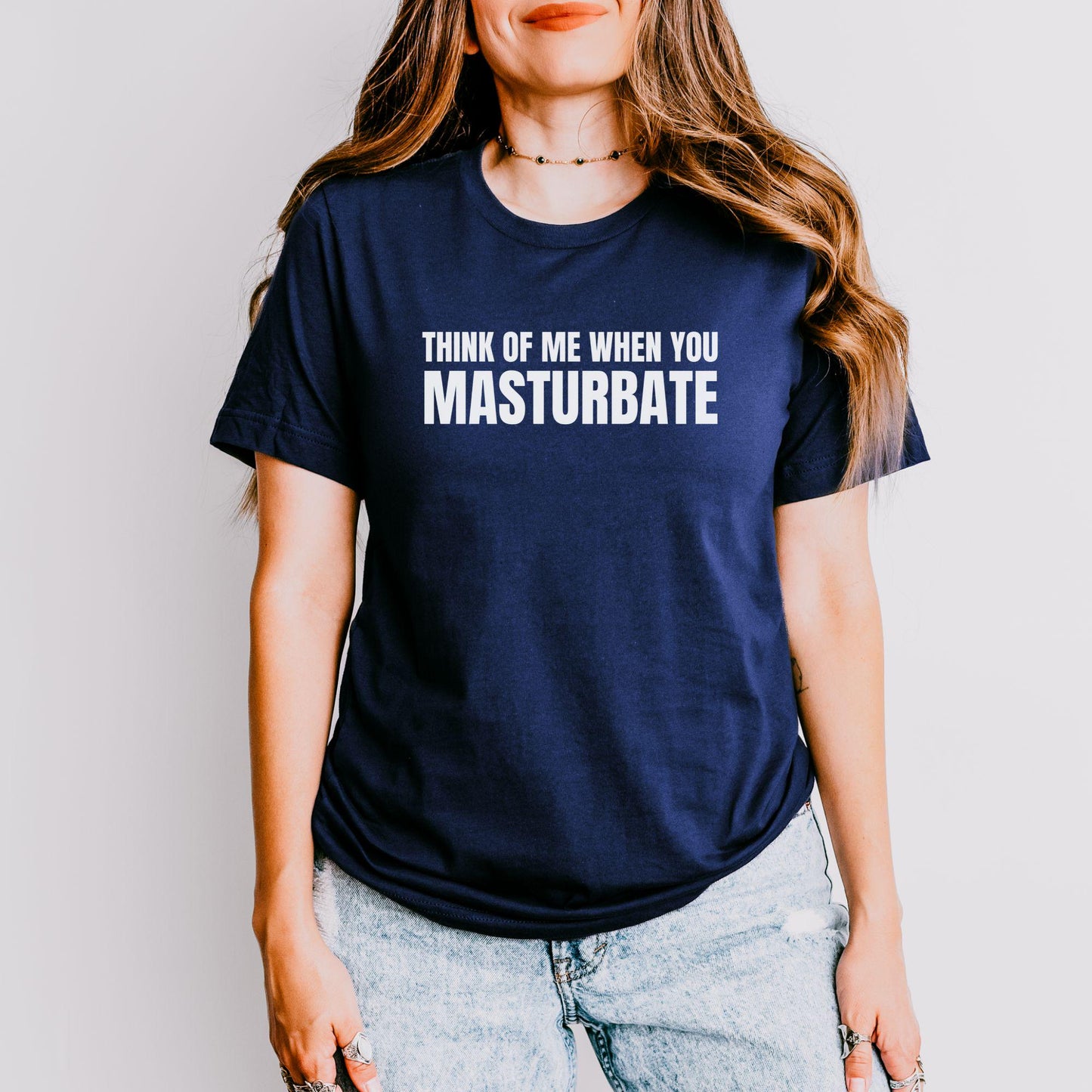 a woman wearing a t - shirt that says, think of me when you mast