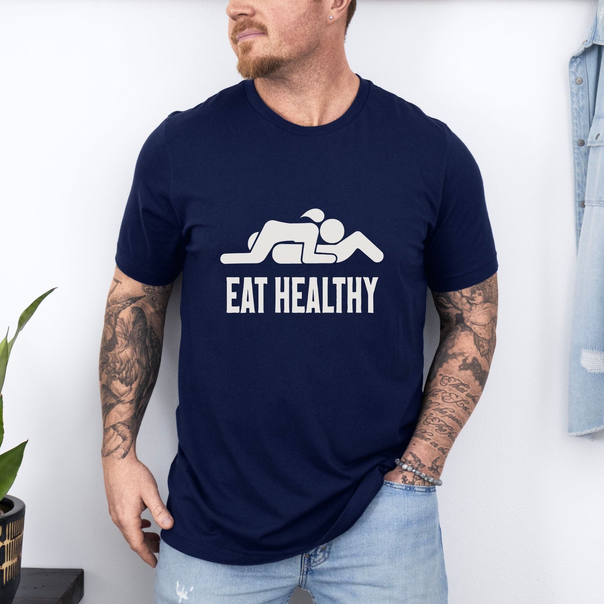 a man wearing a t - shirt that says eat healthy