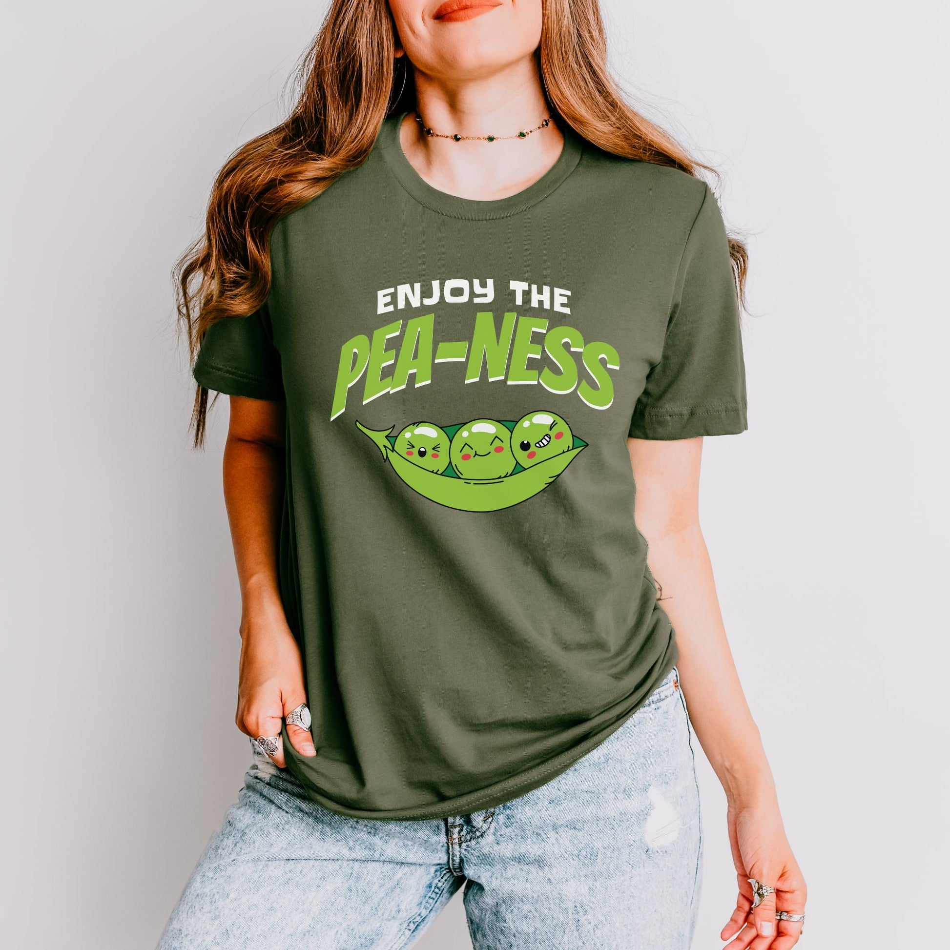 a woman wearing a t - shirt that says enjoy the pea - less