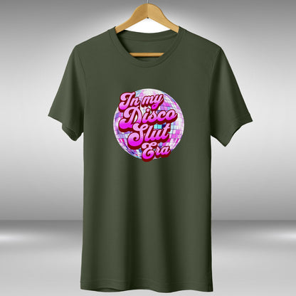 A green t-shirt with a graphic design featuring a disco ball and the text "In my disco slut era" printed on it.