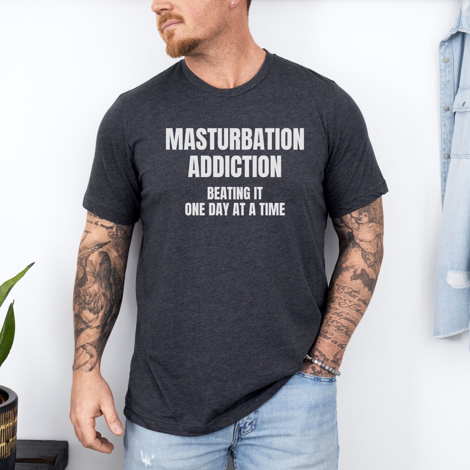 a man wearing a black t - shirt that says, masturption addition being