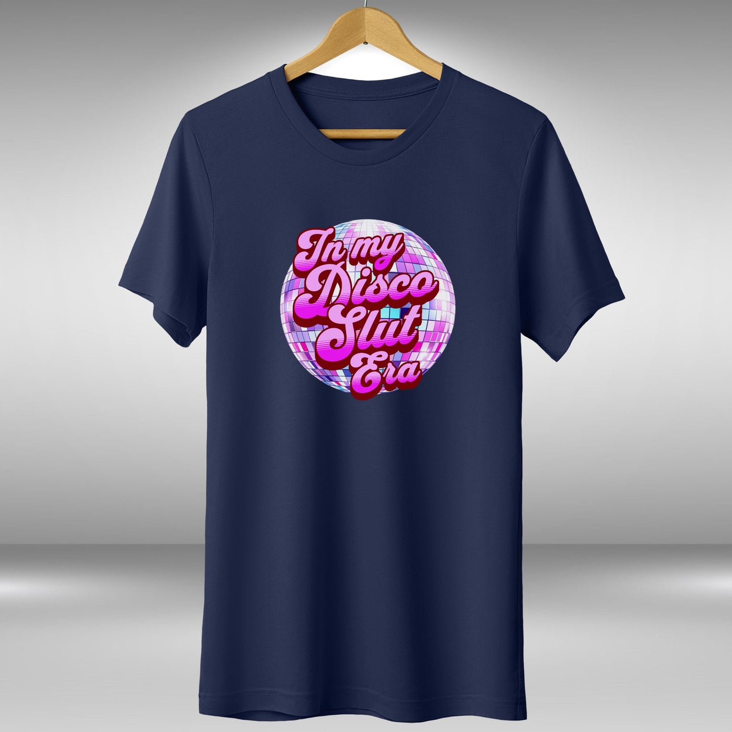 A navy blue t-shirt with a graphic design featuring a disco ball and the text "In my disco slut era" in a stylized font.