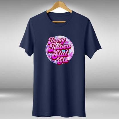 A navy blue t-shirt with a graphic design featuring a disco ball and the text "In my disco slut era" in a stylized font.