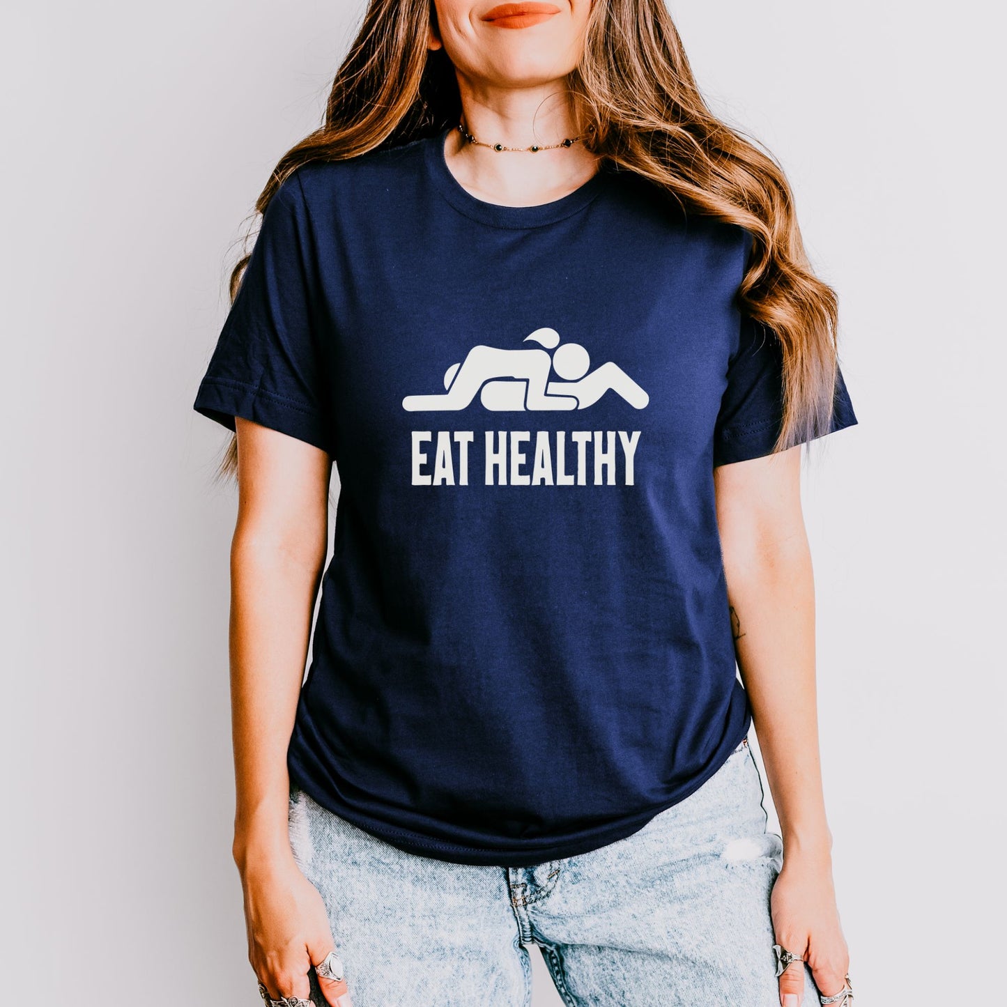 a woman wearing a t - shirt that says eat healthy