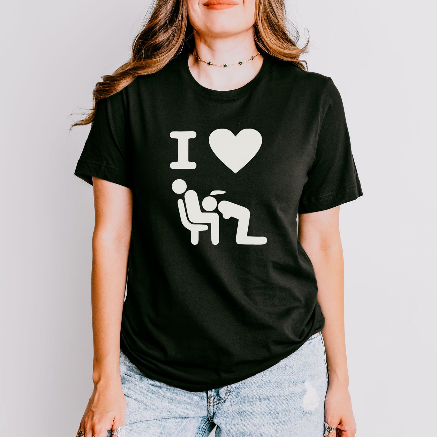 a woman wearing a black t - shirt with a white graphic of a man and